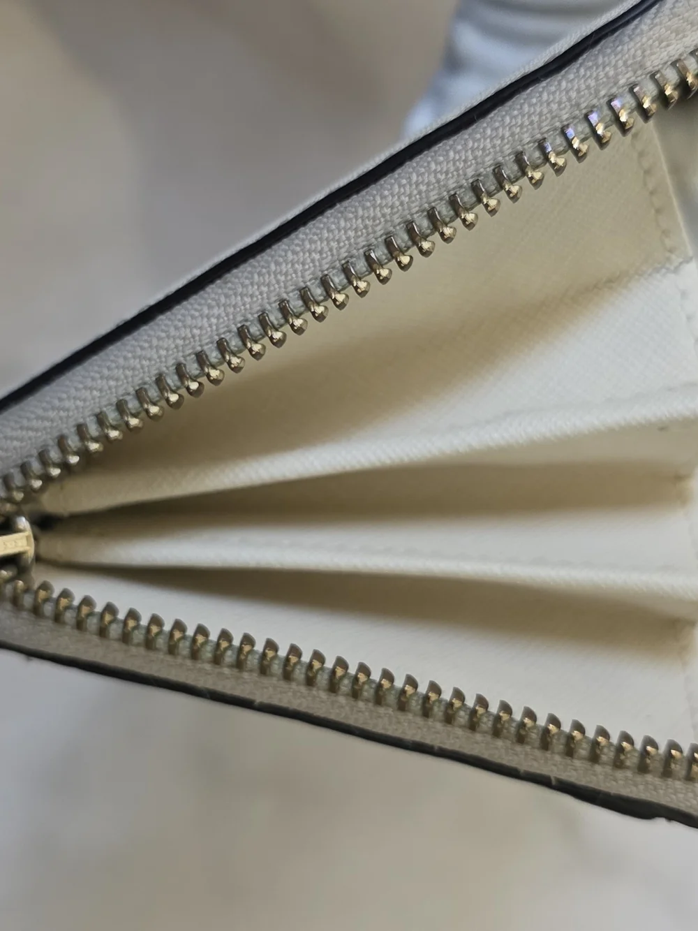 Kate Spade Newbury Lane Neda Zip Around Wallet in Cream Saffiano Leather.